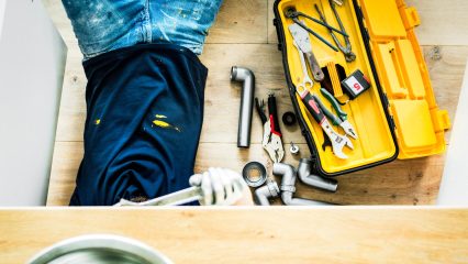 Dan dan the rv man repairing rv plumbing under sink using hand tools in greenville sc